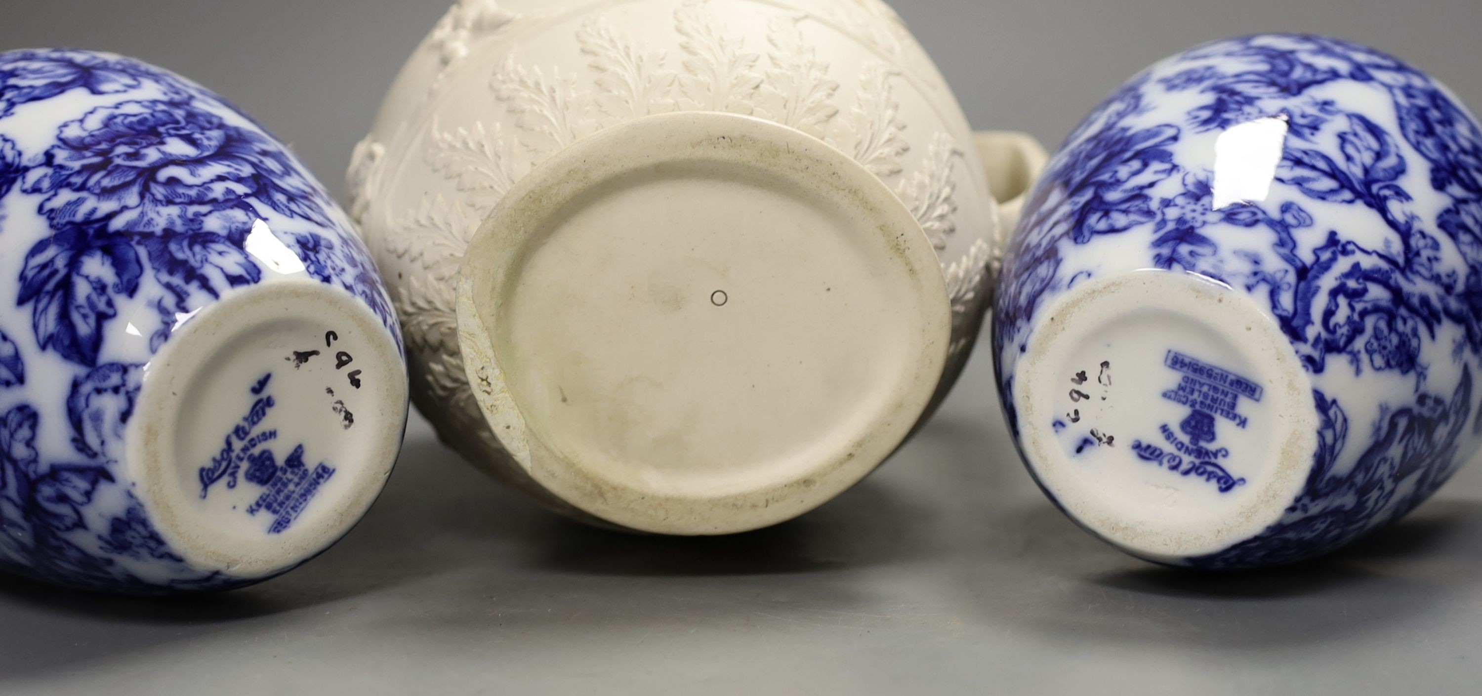 A pair of Keelings blue and white floral vases and a 19th century relief moulded white stoneware jug, vases 17 cms high.